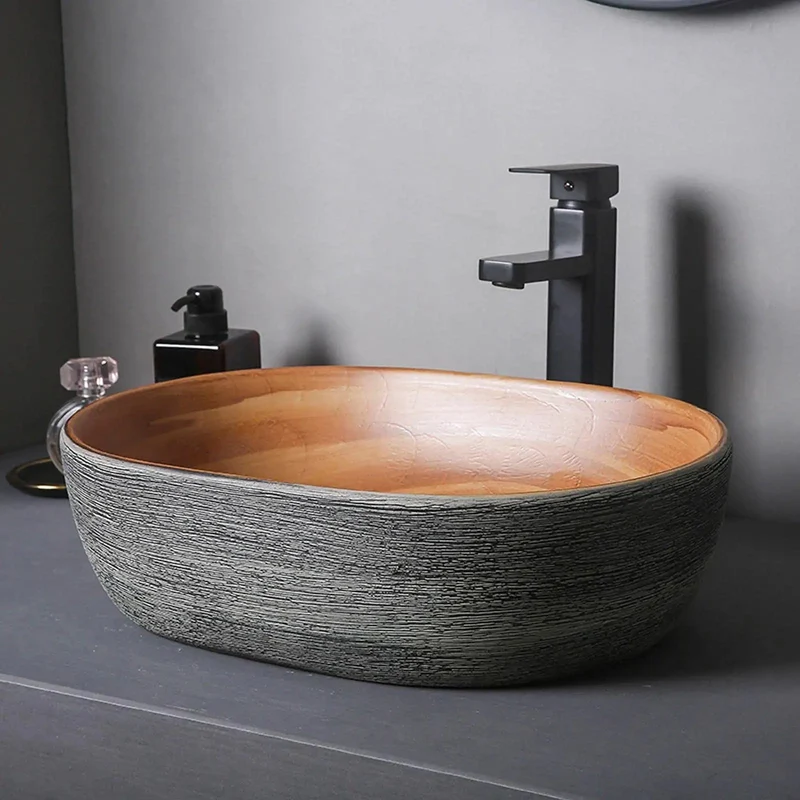 Smooth Glazed Ceramic Countertop Bathroom Sink With Graceful Oval Vessel Shape, Hand Carved Curves That Bring Next Level Vanity Vibes, Heavy Duty Construction Built To Handle Daily Use Without Skipping A Beat, Includes Matched Copper Hardware And